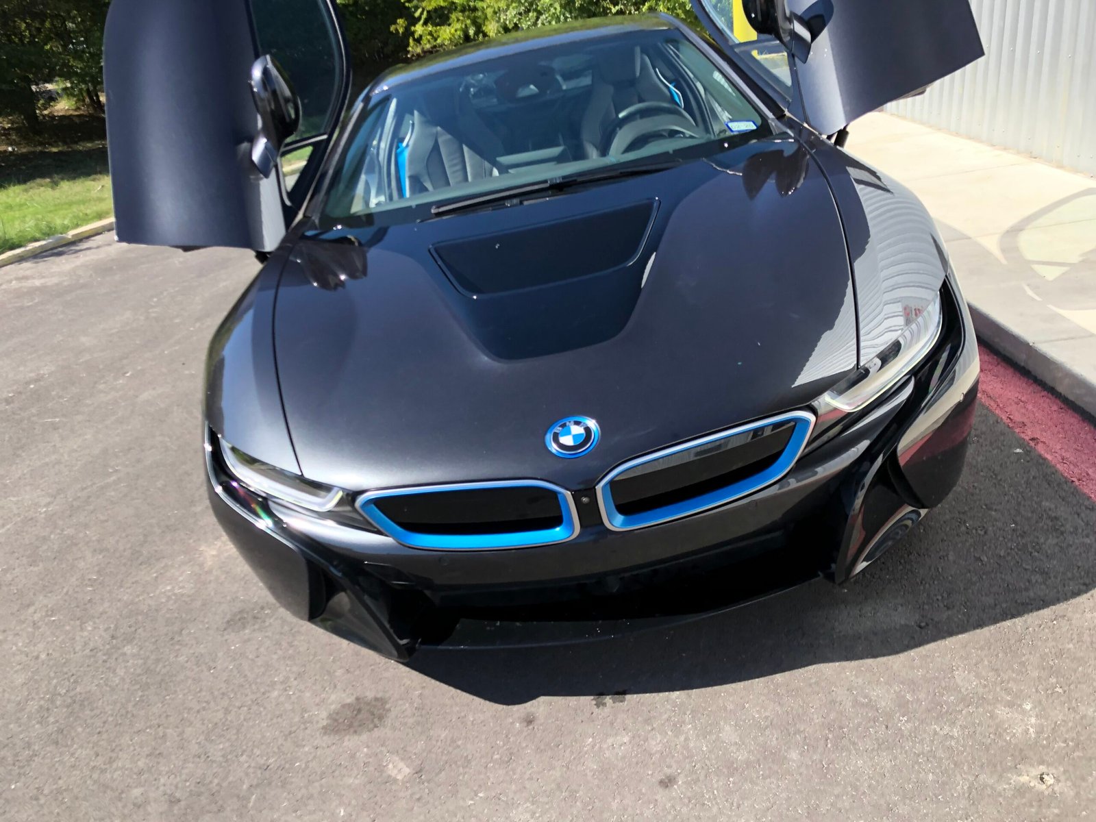 Vehicle hood after paintless dent repair — flawless factory finish restored